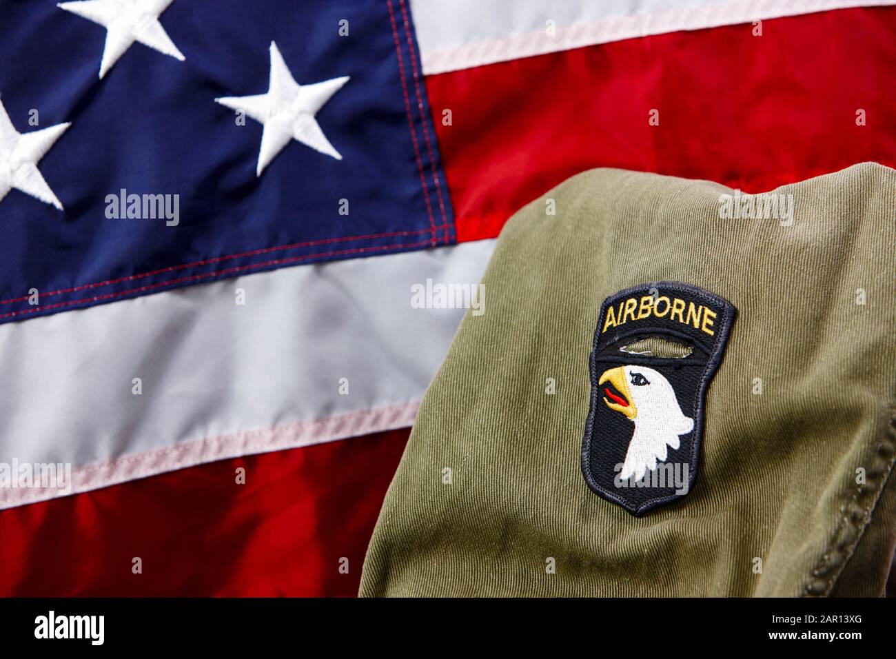 101st airborne division screaming eagles patch on vietnam era uniform in front of united states of america flag Stock Photo