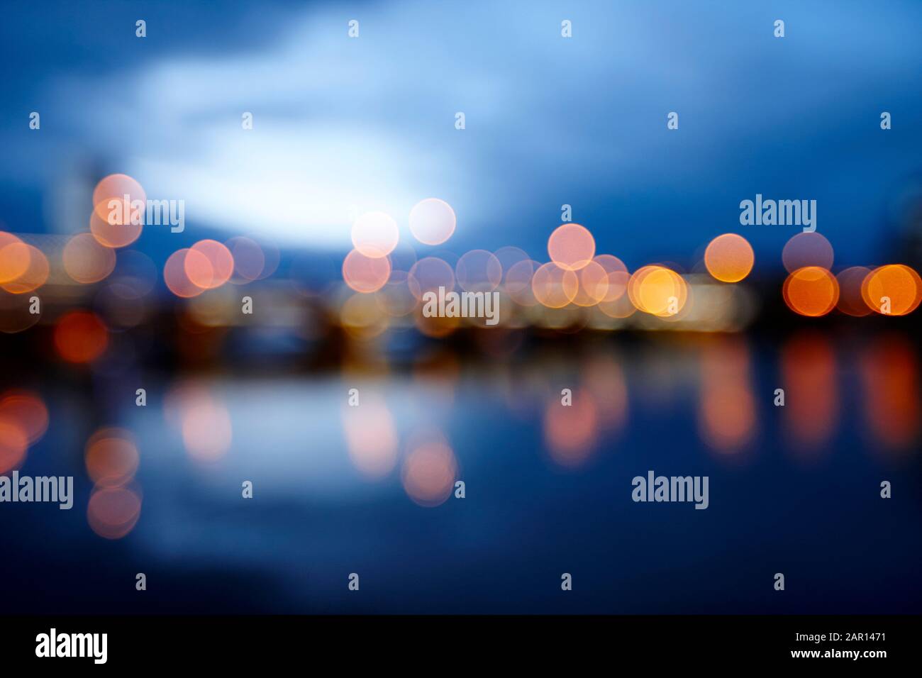 abstract out of focus photograph of queens bridge and river lagan Belfast waterfront at night Northern Ireland UK possible use blurred vision eyesight Stock Photo