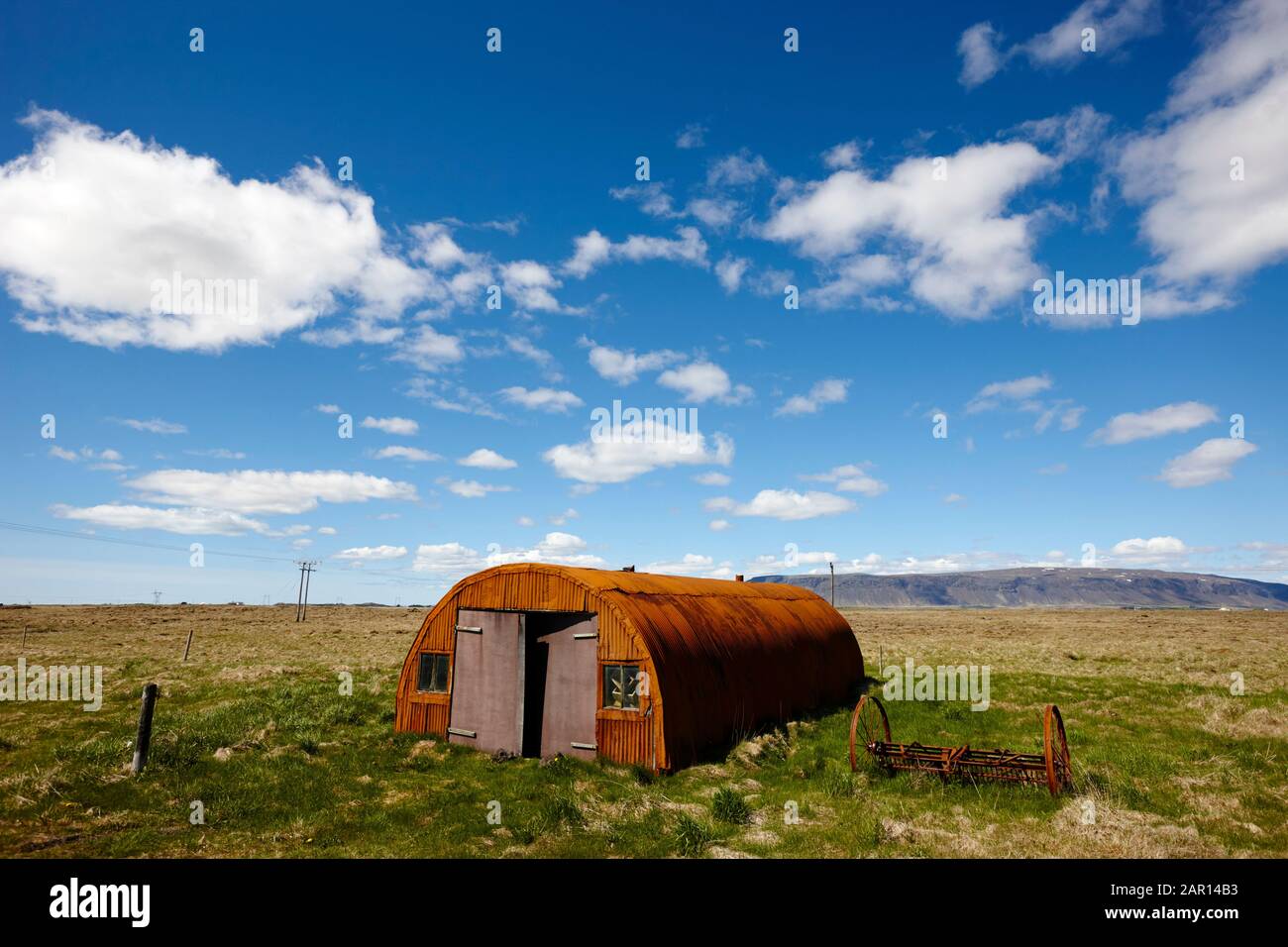 old rusted corrugated iron nissen quonset hut farm building rural remote southern iceland originally built in ww2 to house american navy personnel Stock Photo