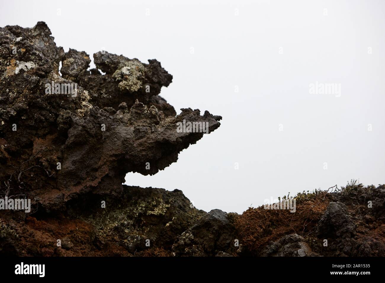 formation of lava rock in lava field which resembles a face giving rise to the icelandic rock trolls legends iceland Stock Photo