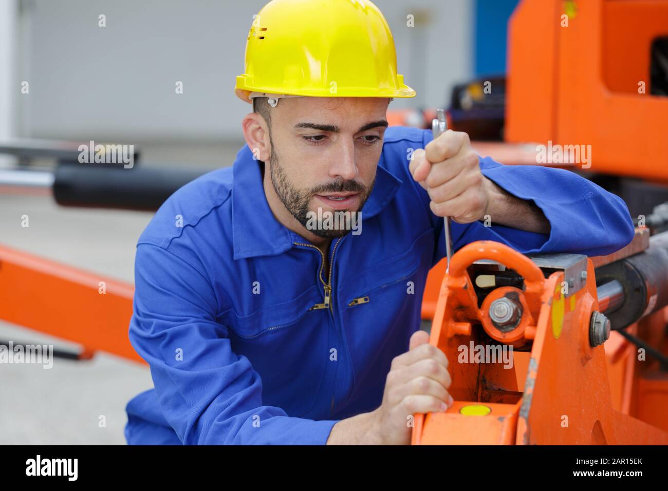 portrait of mechanic doing hydraulic repair Stock Photo Alamy