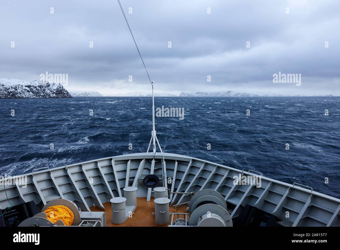 sailing through the Arctic Norwegian fjords during winter and rough seas in Finnmark Norway Stock Photo
