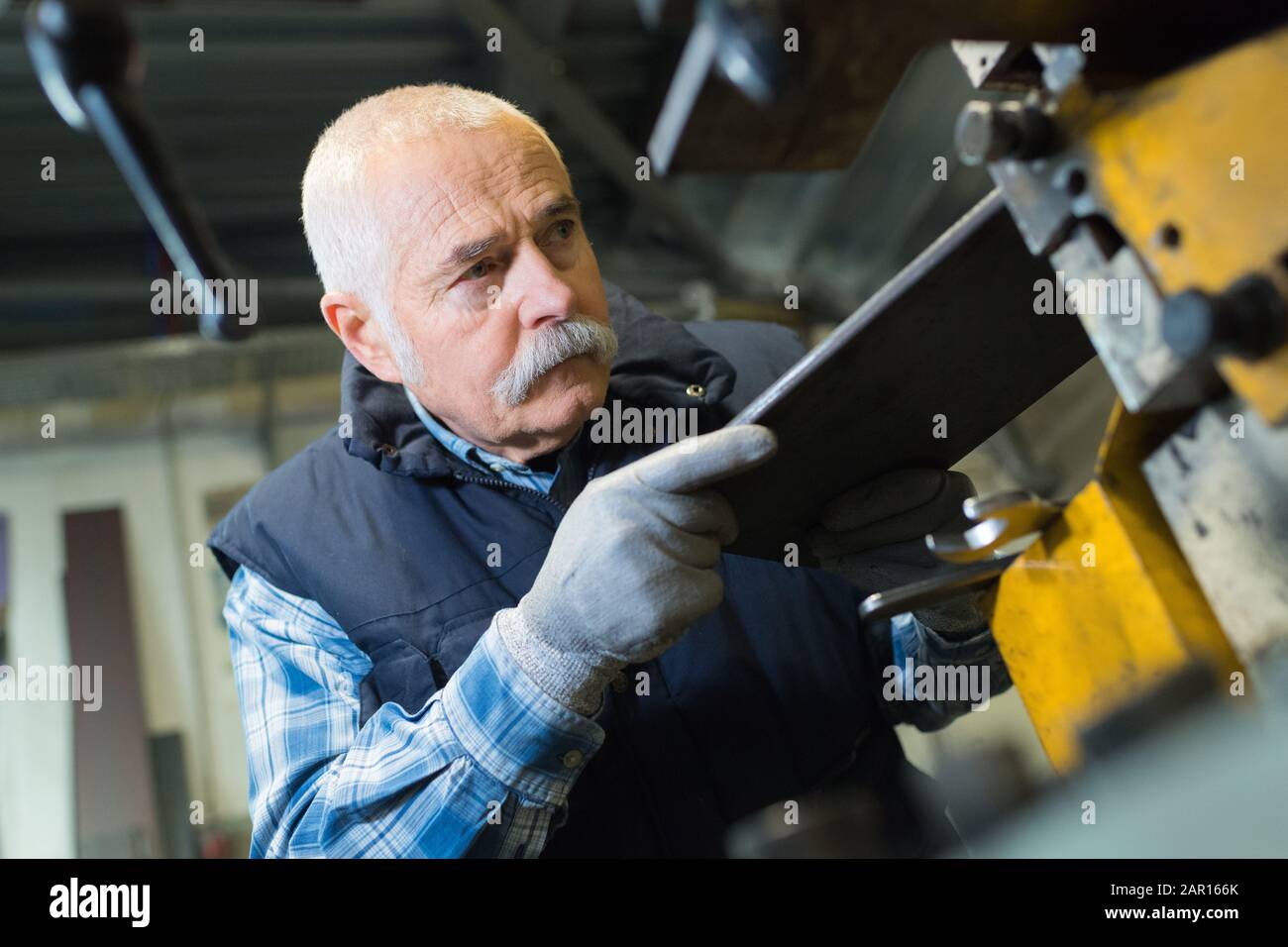 senior mechanic works at the lathe Stock Photo - Alamy