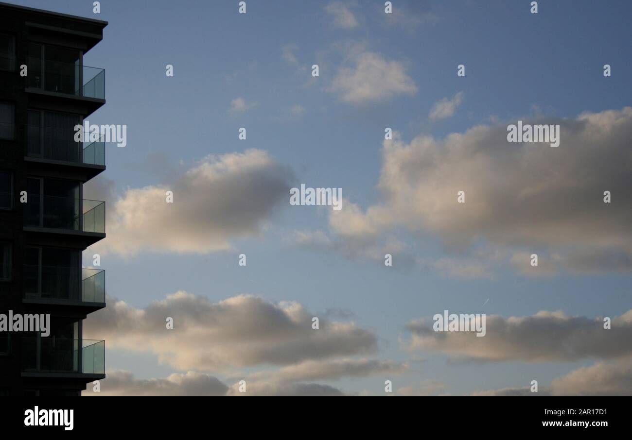 Corner of apartment building against a cloudy sky. Stock Photo