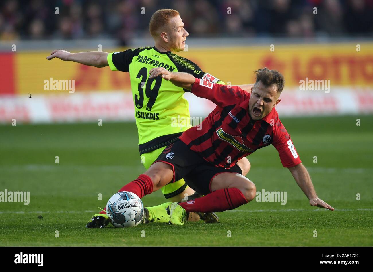 Freiburg, Germany. 25th Jan, 2020. Football: Bundesliga, SC Freiburg - SC Paderborn 07, 19th matchday in the Black Forest Stadium. Sebastian Vasiliadis (l) from Paderborn and Amir Abrashi (r) from Freiburg fight for the ball. Credit: Patrick Seeger/dpa - IMPORTANT NOTE: In accordance with the regulations of the DFL Deutsche Fußball Liga and the DFB Deutscher Fußball-Bund, it is prohibited to exploit or have exploited in the stadium and/or from the game taken photographs in the form of sequence images and/or video-like photo series./dpa/Alamy Live News Credit: dpa picture alliance/Alamy Live Ne Stock Photo