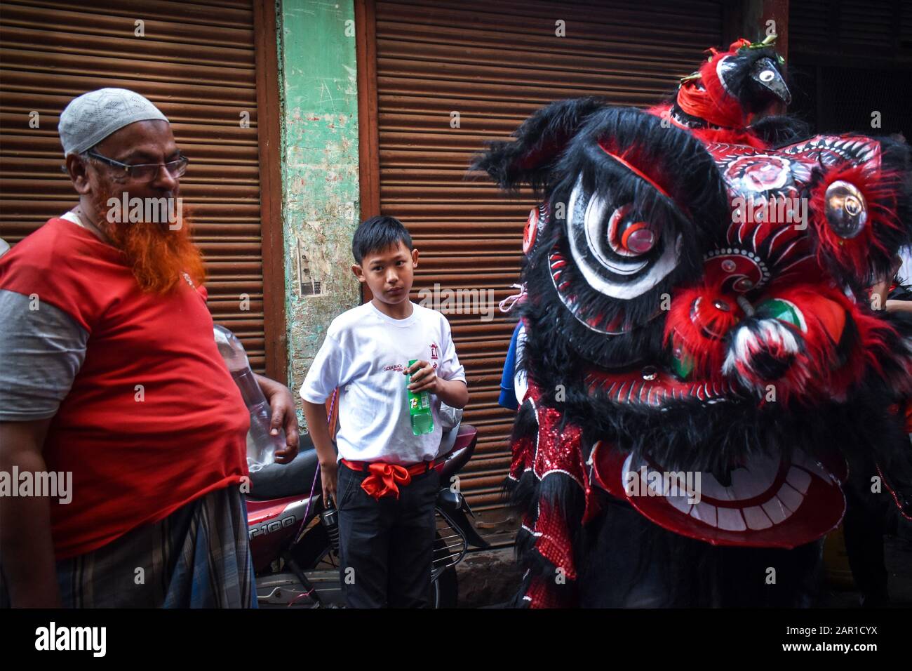 A Muslim person is enjoying the Dragon Dance on Chinese New year at Kolkata, India. Stock Photo