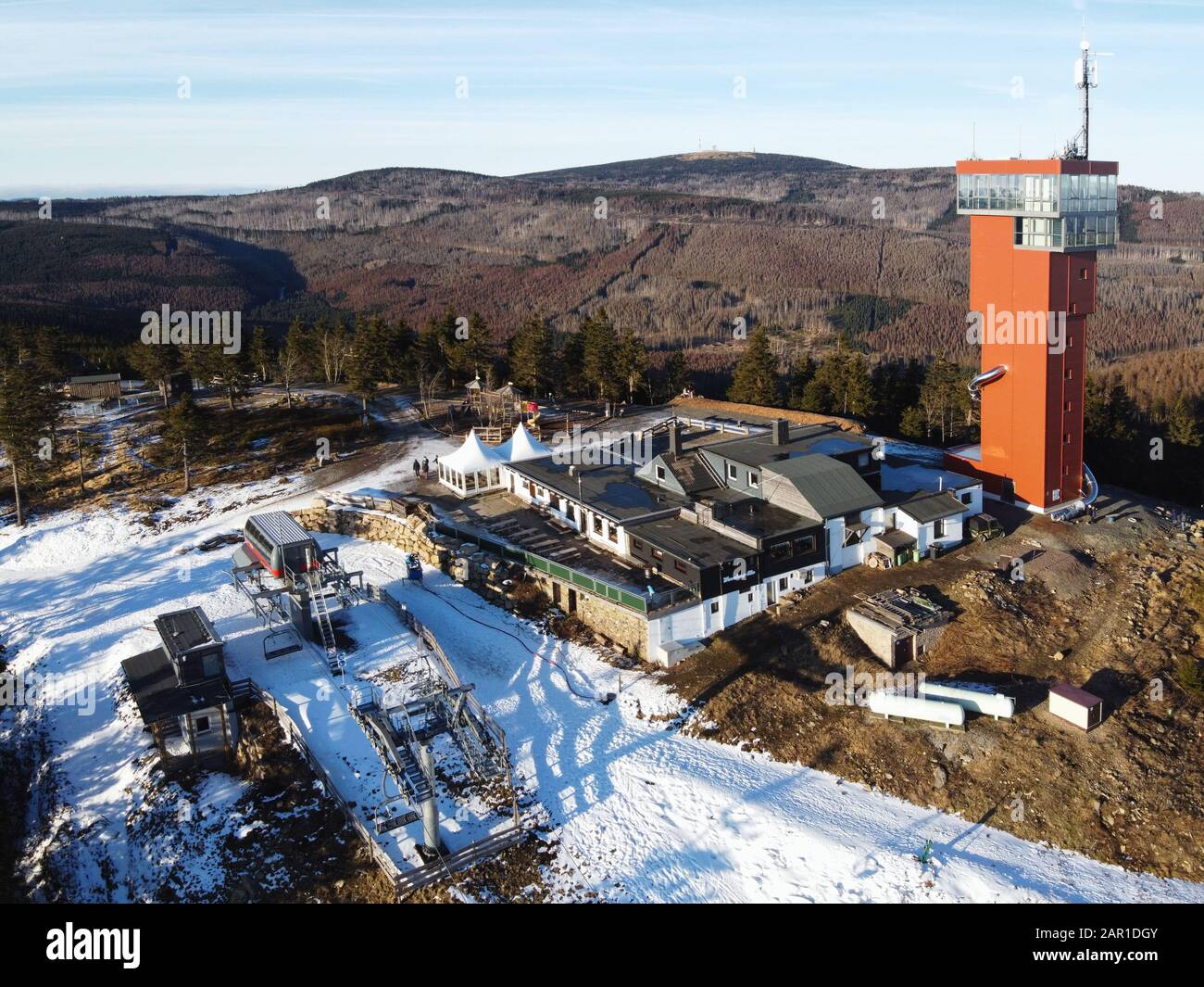 Aerial drone view of Mount Wurmberg with Mount Brocken in the background. Newly built lookout tower on the summit plateau. Harz mountains, Germany. Stock Photo