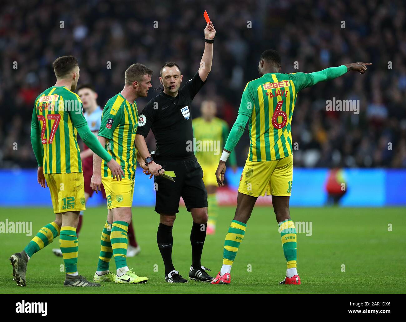 West Bromwich Albion's Semi Ajayi is shown a red card by referee Stuart Attwell after picking up a second booking during the FA Cup fourth round match at the London Stadium. Stock Photo