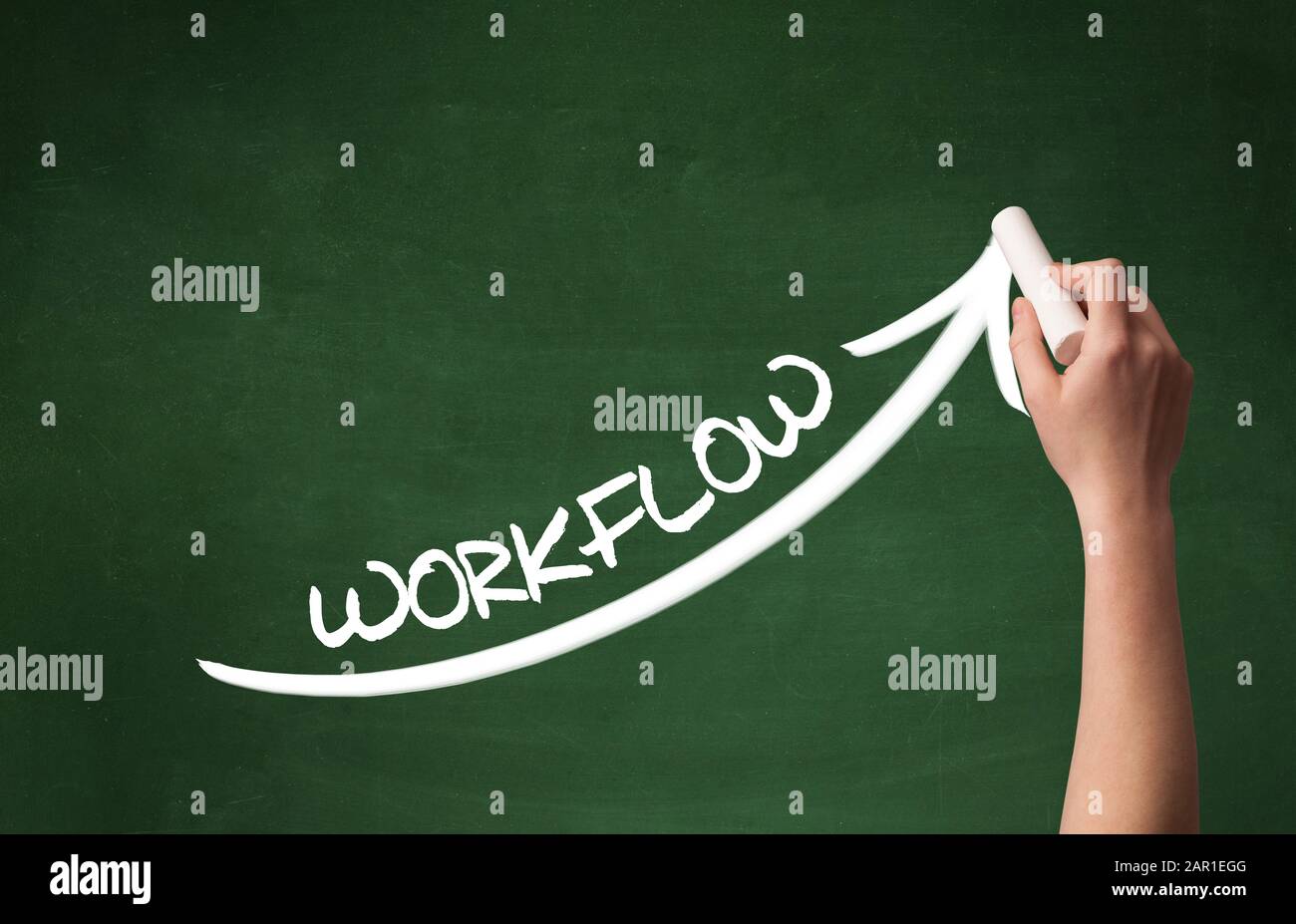 Hand drawing WORKFLOW inscription with white chalk on blackboard ...