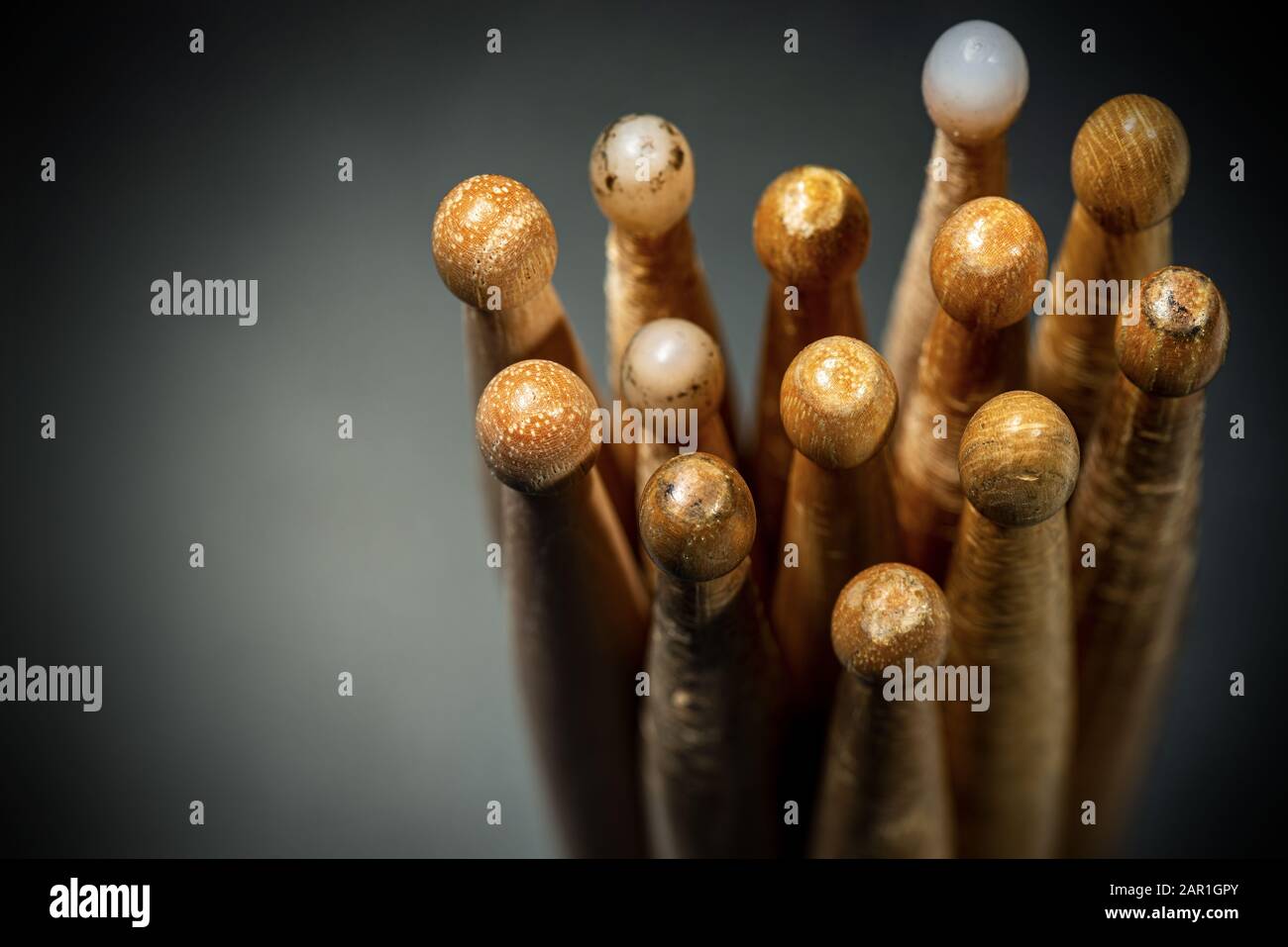 Close-up of a group of used wooden drumsticks on a dark background with copy space. Percussion instrument Stock Photo