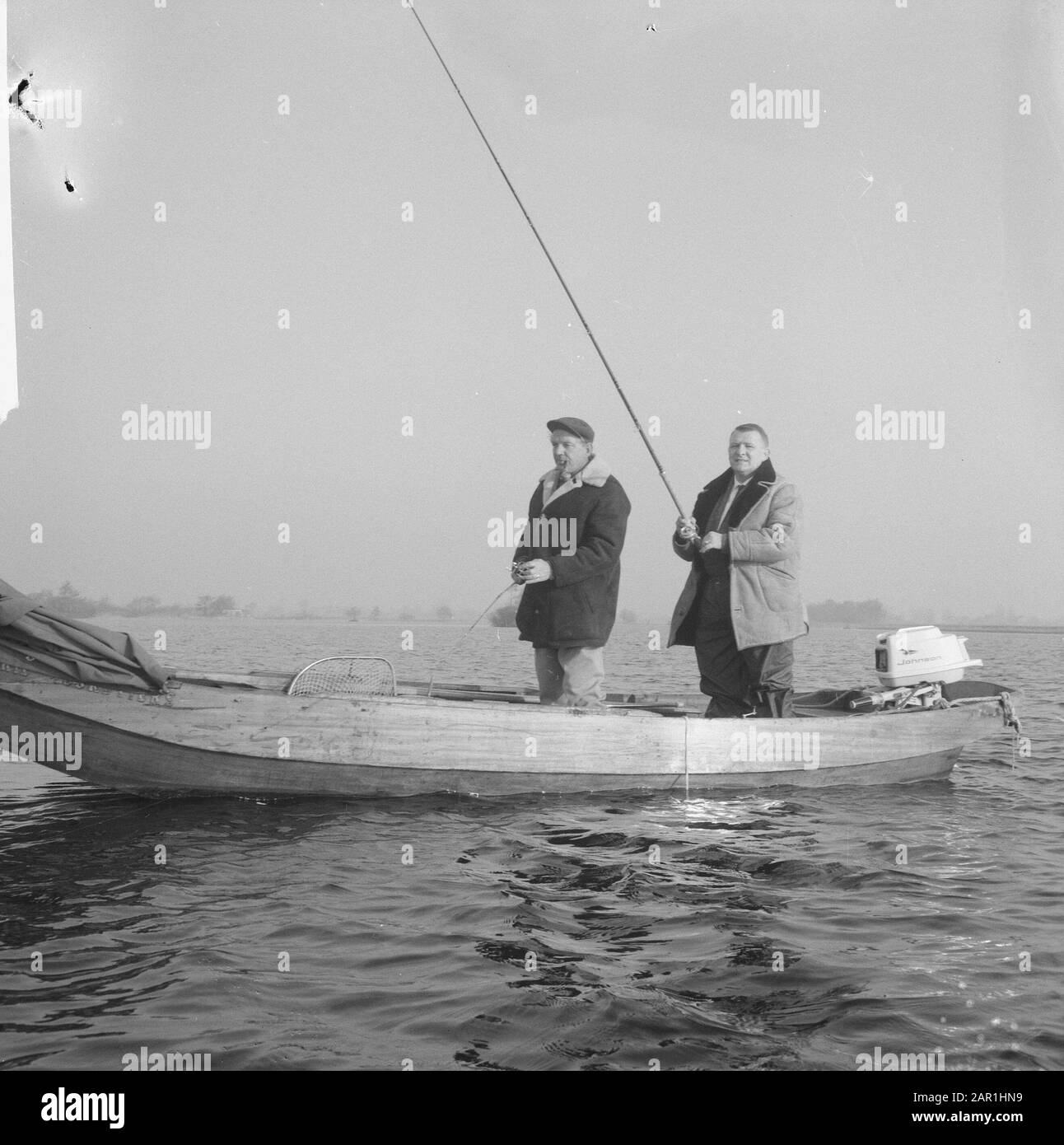 Two men fishing in motor boat Black and White Stock Photos & Images - Alamy