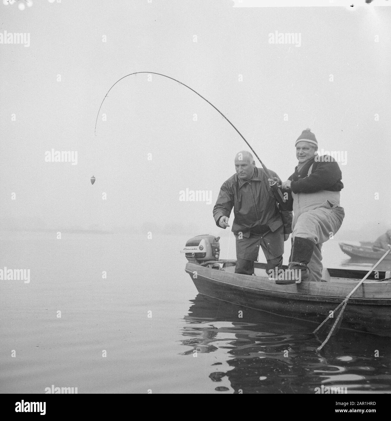 Fishing fishermen in exercising their hobby Two men fishing from a motor  boat Date: 14 November 1965 Keywords: fishing, motor boats Stock Photo -  Alamy
