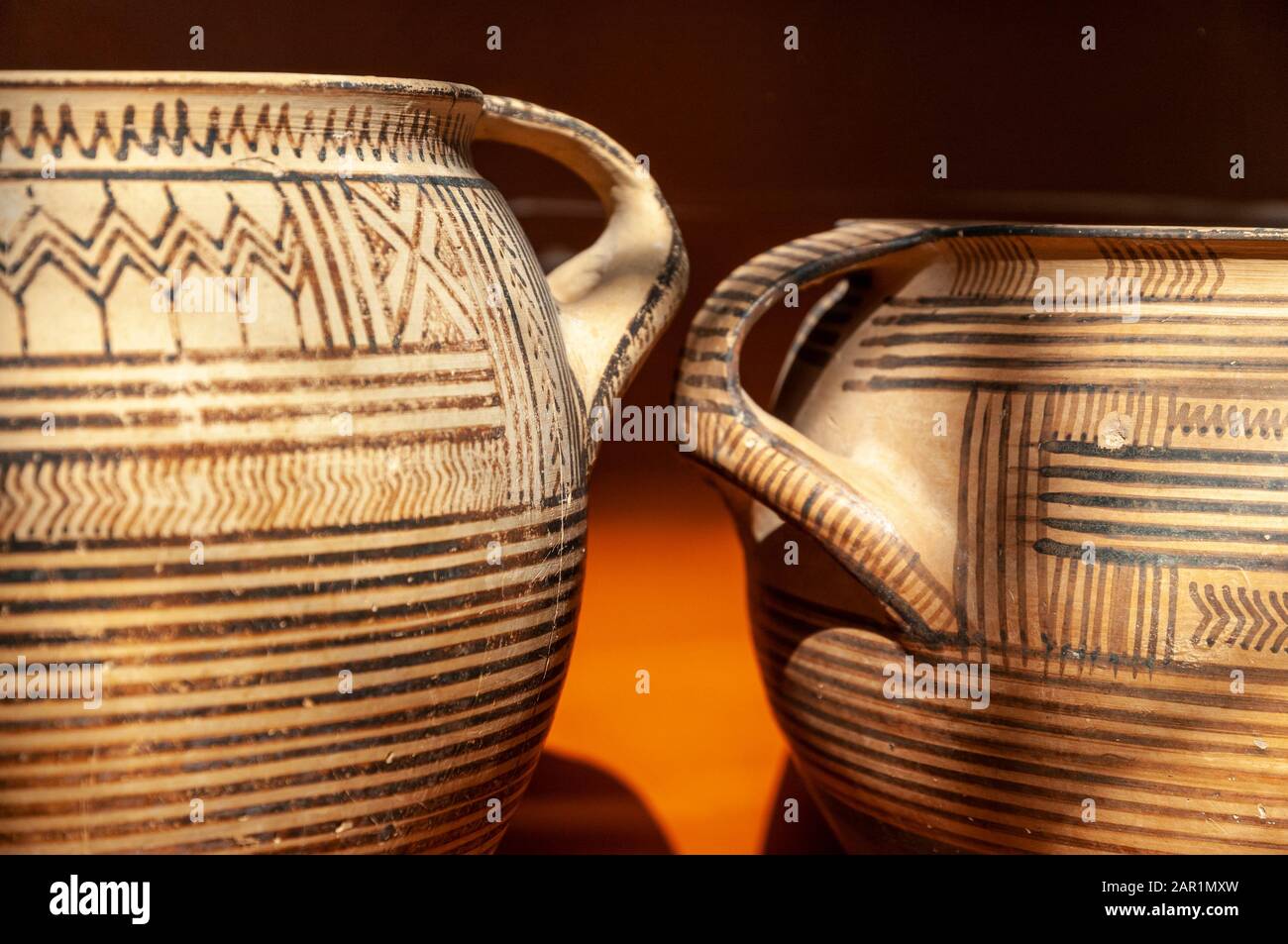 A museum display of early Greek ceramics, Geometric Kraters, funerary urns, from 750-720bc.  from graves at Ancient Corinth, Peloponnese, Greece. Stock Photo