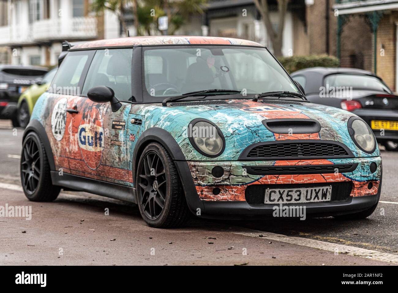 A modern BMW Mini car with vintage aged look Gulf racing colours. Distressed wrap racing scheme with Gulf Oil sponsorship worn on Le Mans race cars Stock Photo