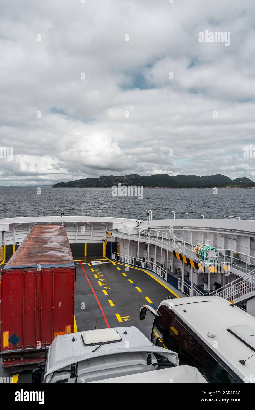 Car deck of the car ferry between Halhjem and Sandvikvåg with trucks and buses on board, Norway Stock Photo