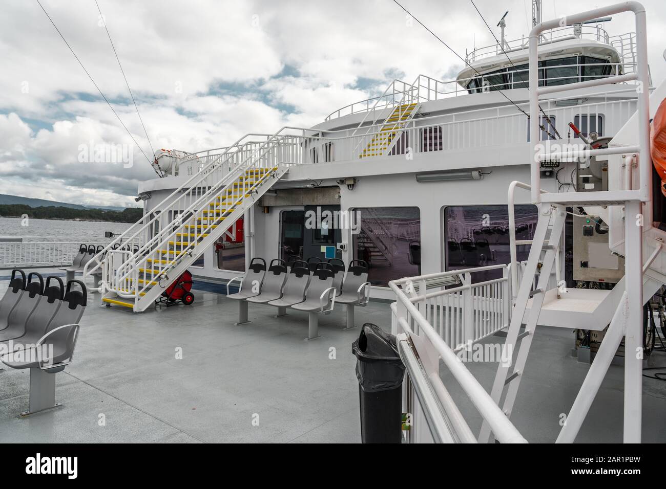 Outside on the empty upper deck of the car ferry between Halhjem and Sandvikvåg, Norway Stock Photo