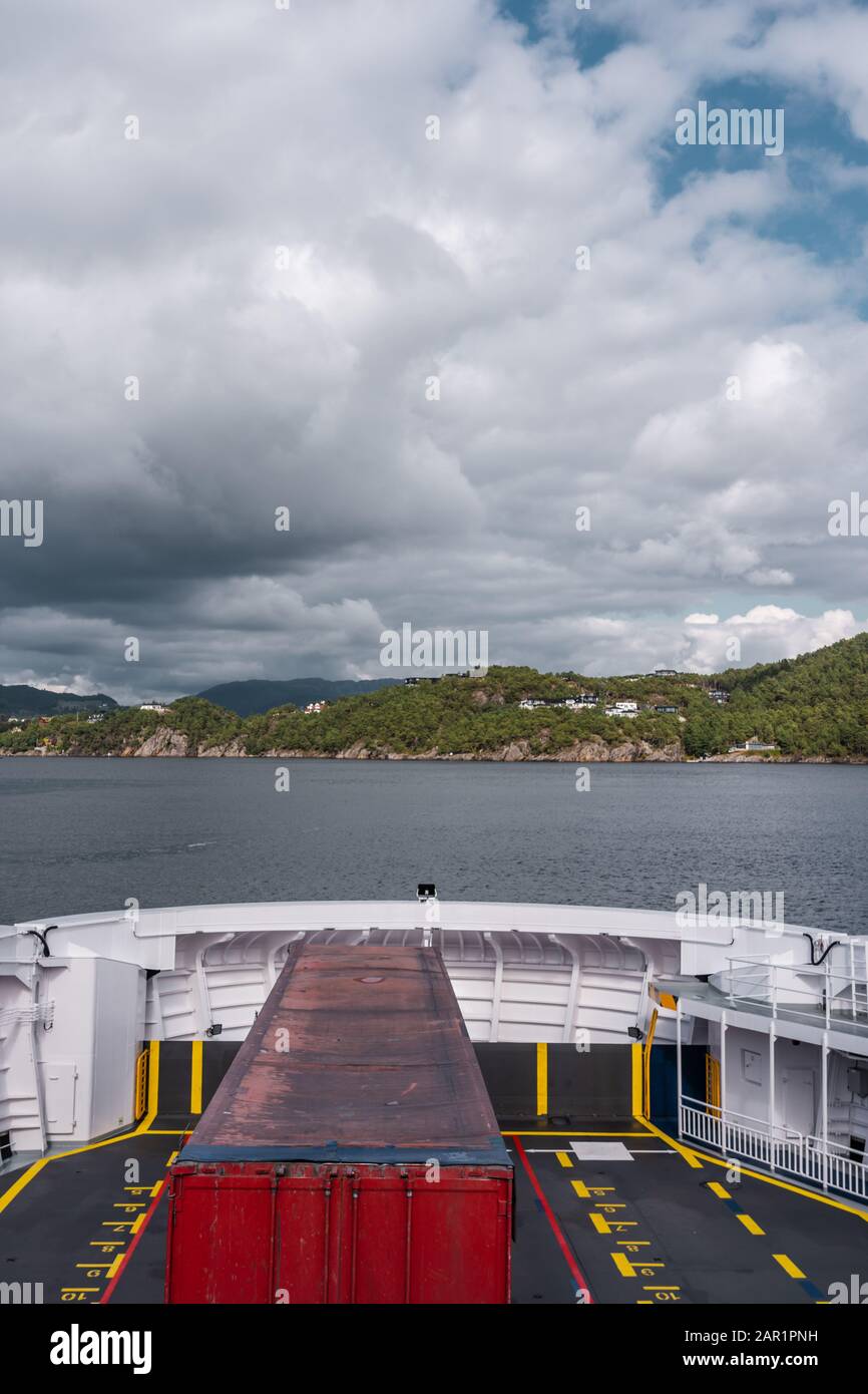 Norway, Truck being transported on a car ferry from Halhjem to Sandvikvåg with land in sight Stock Photo