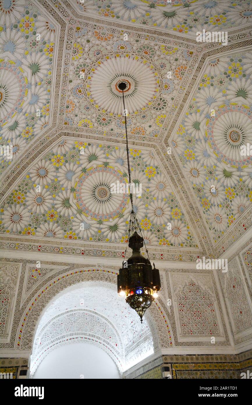 A hanging lantern and Islamic geometrical and floral motifs from a 19th century mansion ceiling in the Bardo National Museum, Tunis Tunisia. Stock Photo