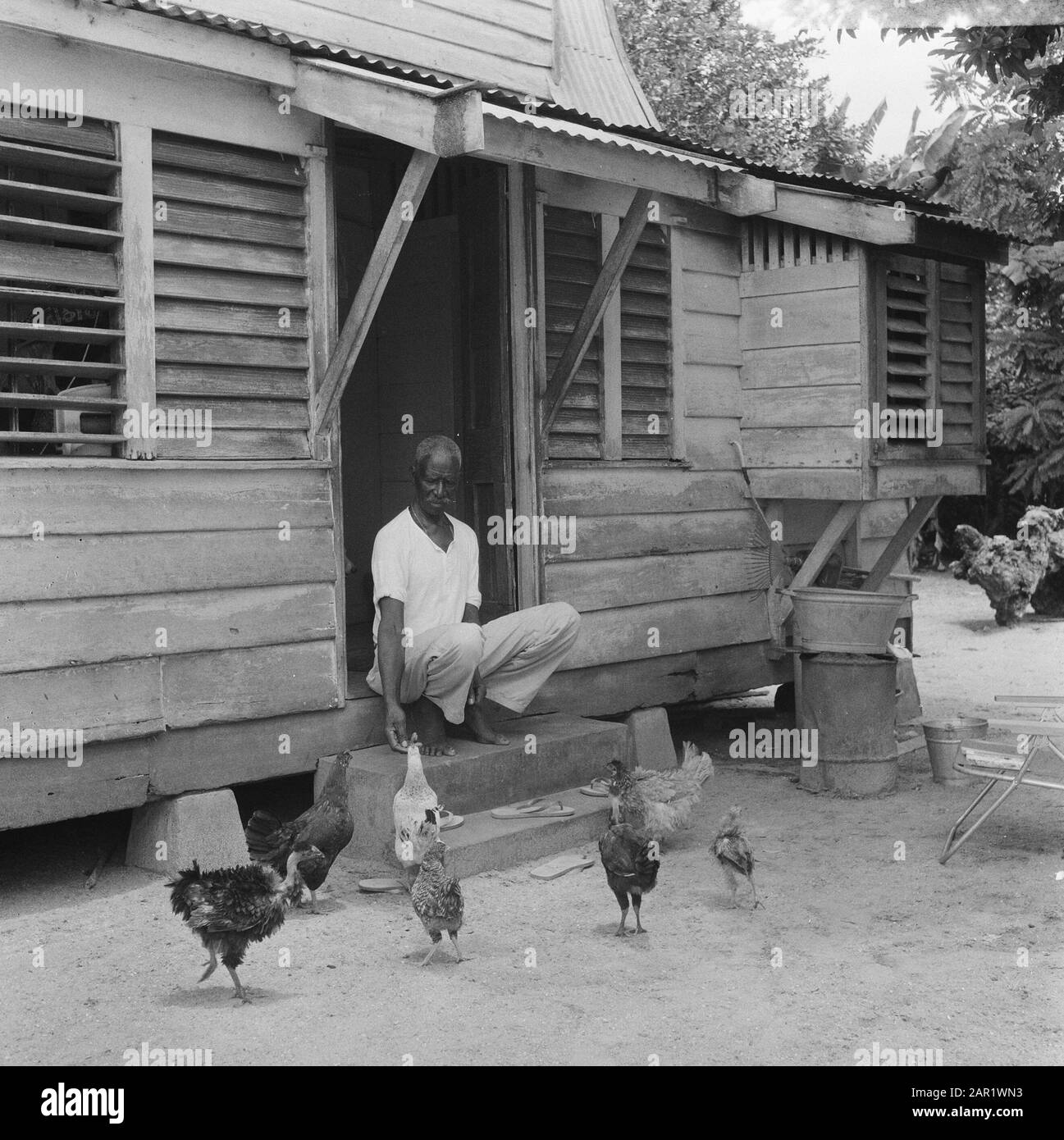 Suriname, Surinamer for his house with chickens Date: May 31, 1967 Location: Suriname Keywords: KIPHN, houses Stock Photo