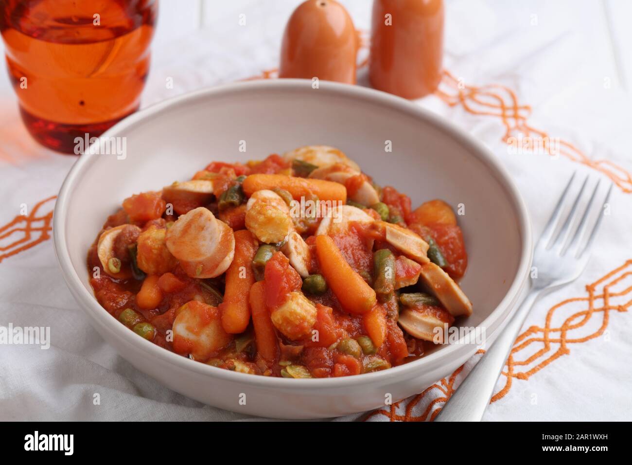 Chicken sausage and vegetable ragout with carrot, corn, green bean, pepper, green pea, and tomato sauce Stock Photo