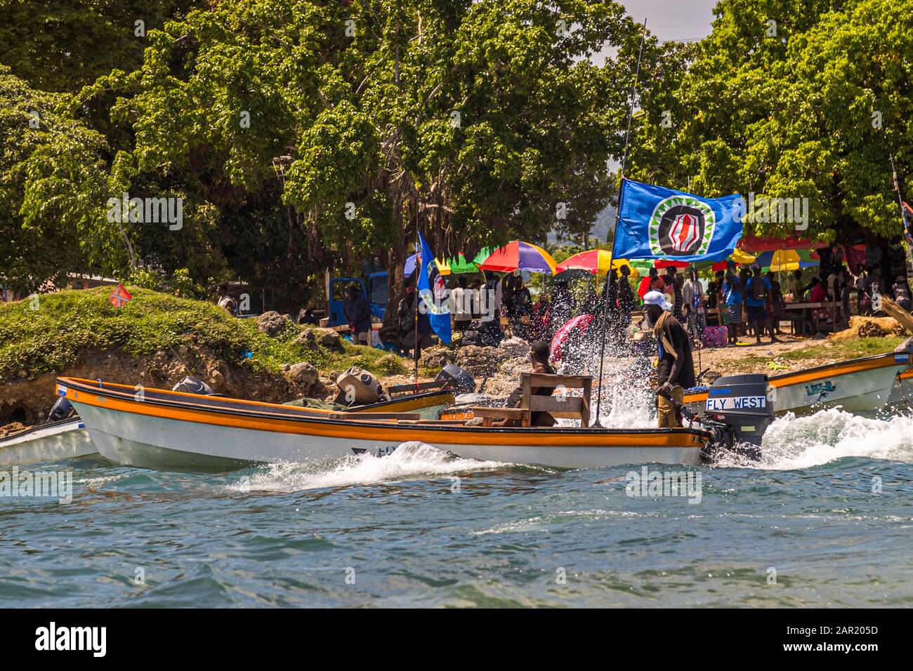 Locals from Bougainville in a small ferry boat with the independence flag from Papua New Guinea hoisted Stock Photo