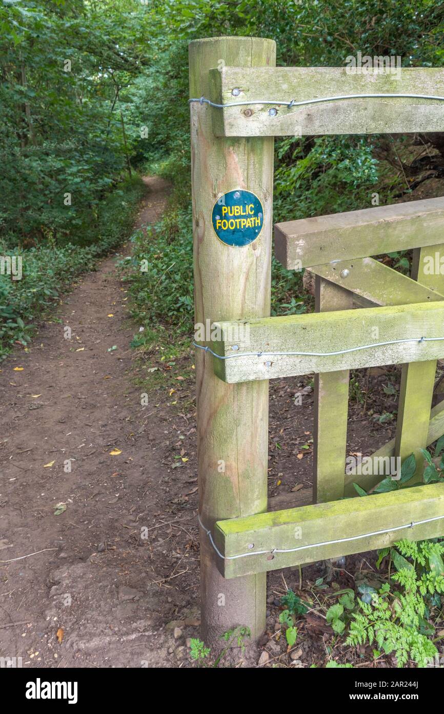 A fence and post bearing a public footpath sign at an entrance to Deepdale Wood nature reserve, Barnard Castle, Teesdale, County Durham, England, UK. Stock Photo