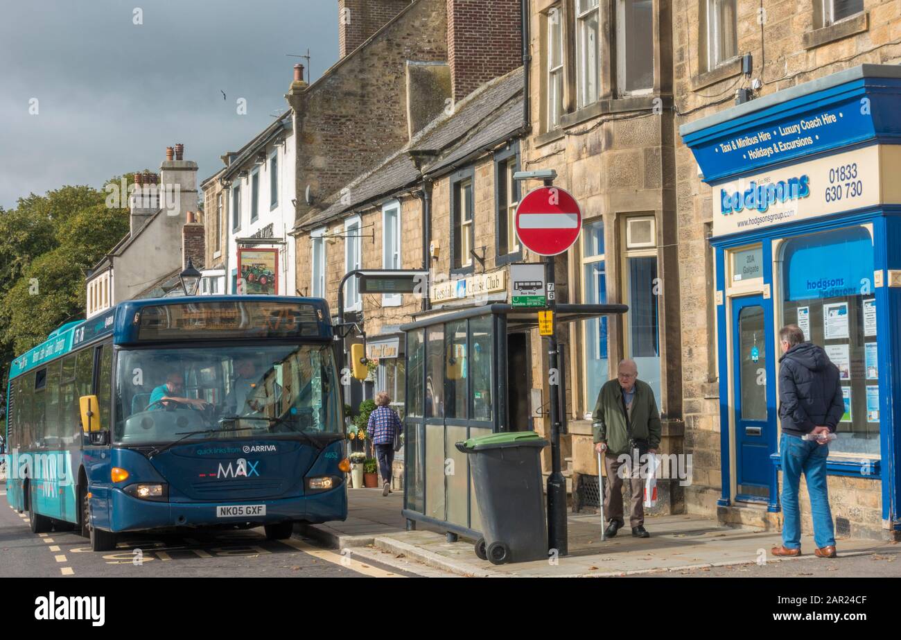 Arriva bus at a stop among period shops, buildings and people, in the historic market town of Barnard Castle, Teesdale, County Durham, England, UK. Stock Photo