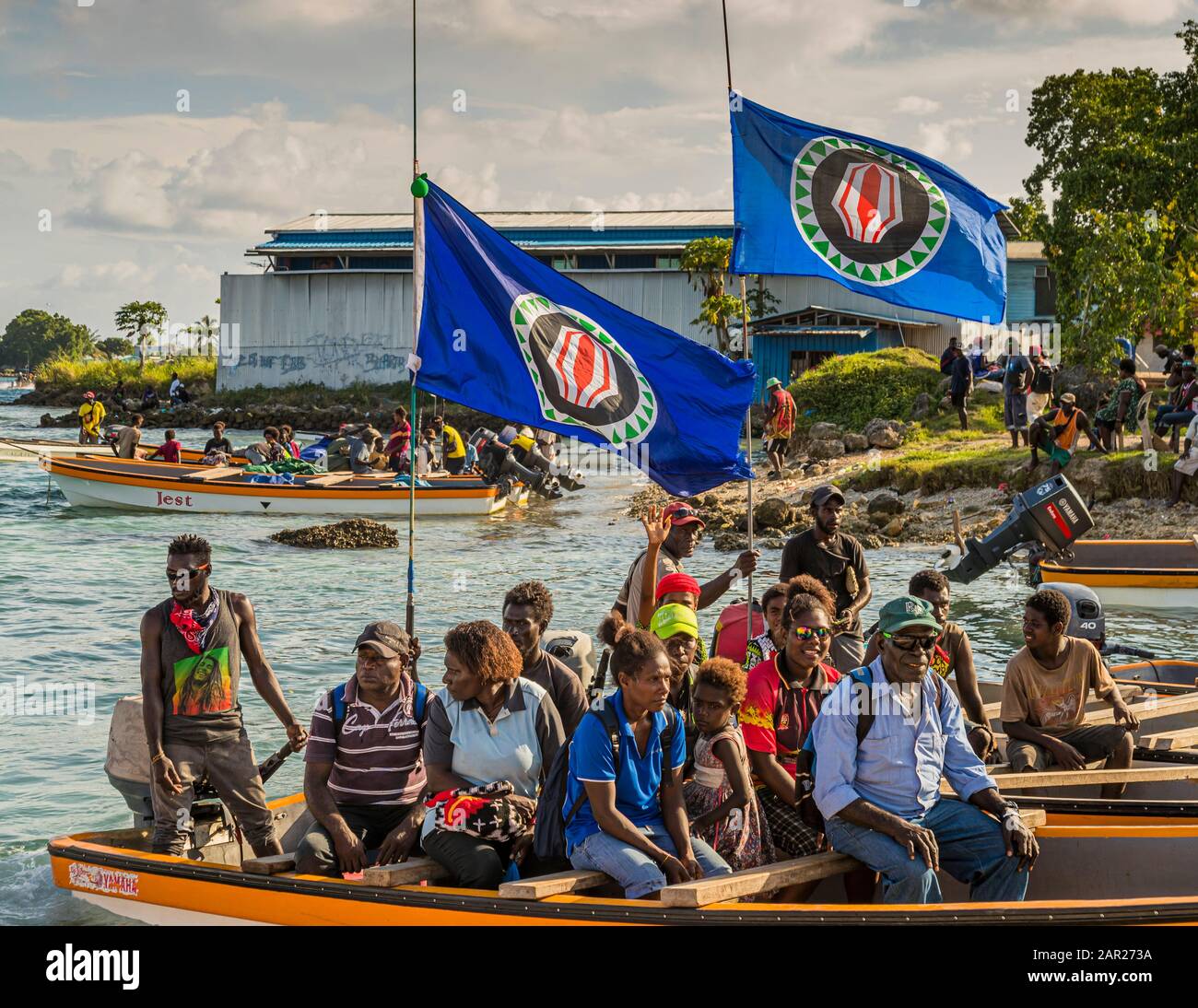 Locals from Bougainville in a small ferry boat with the independence flag from Papua New Guinea hoisted Stock Photo