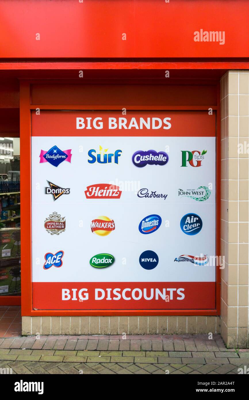 Sign outside Poundstretcher discount store listing the brands on which they offer discounts. Stock Photo