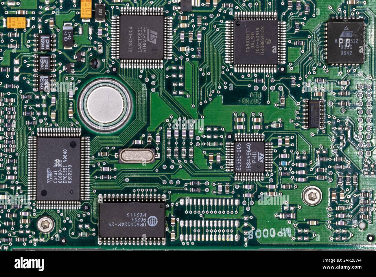 Green digital circuit board of computer harddrive showing metal printed