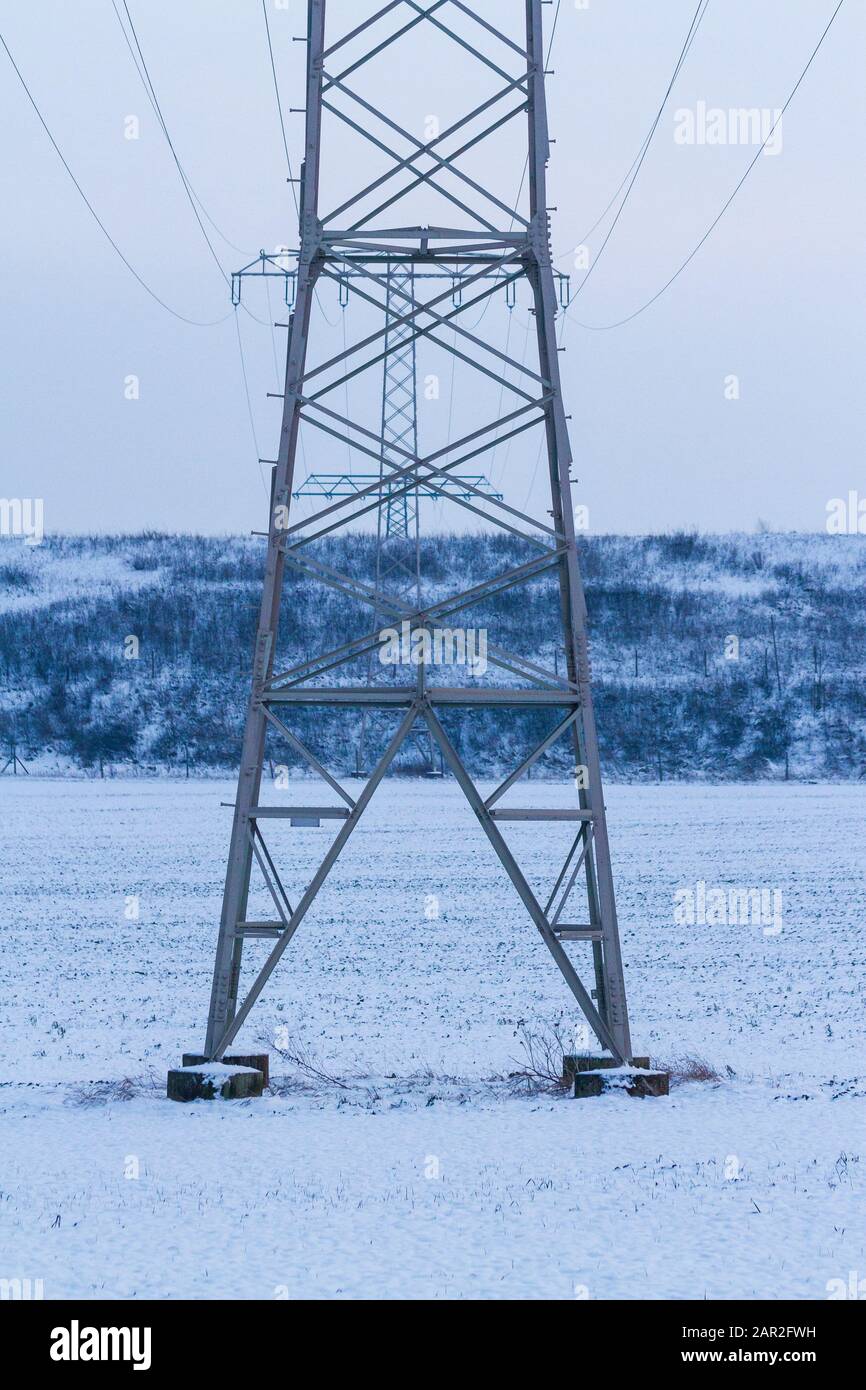 electric powerlines in a evening winter landscape, germany, jena Stock Photo