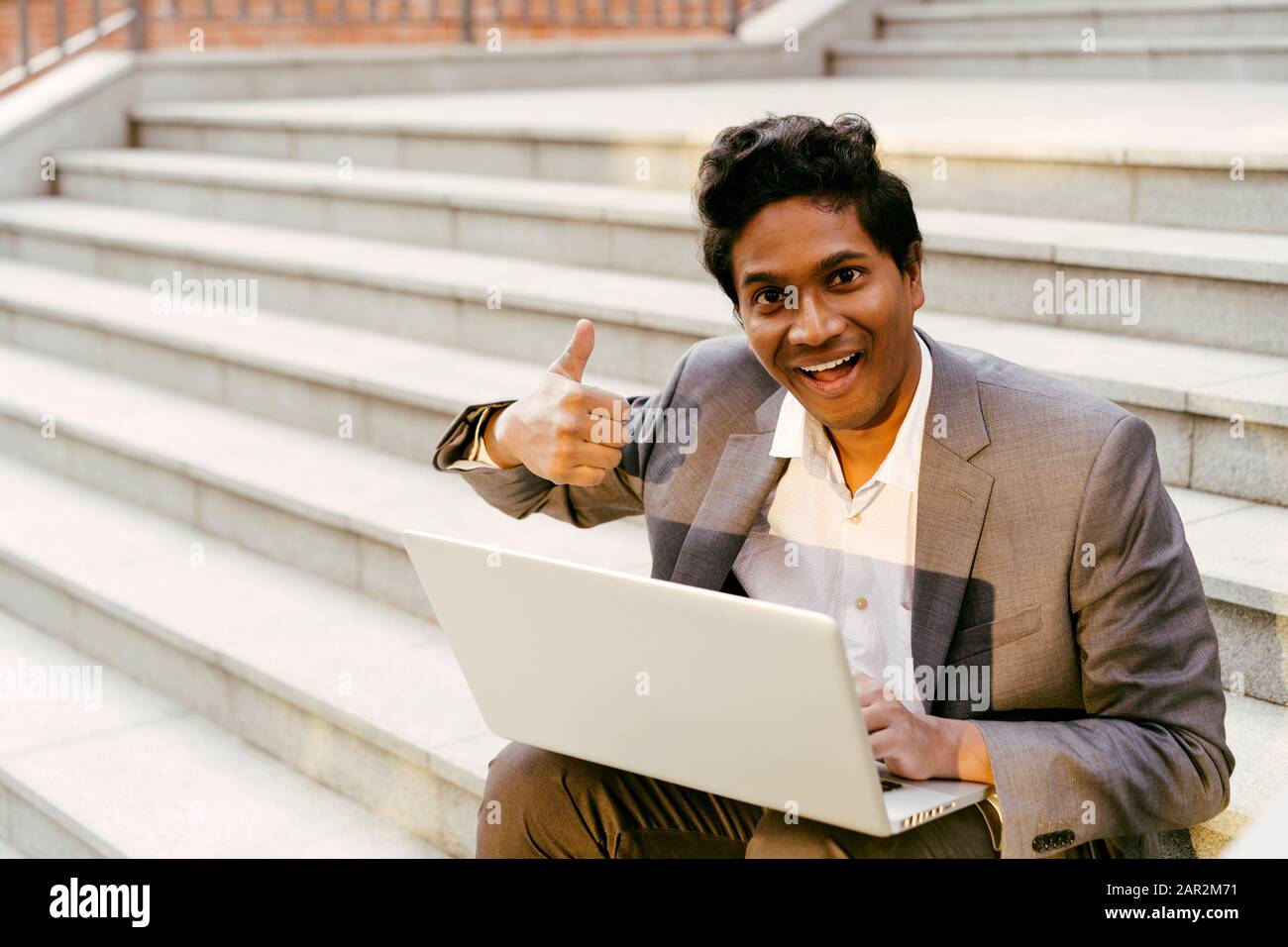 Indian man sitting on steps hi-res stock photography and images - Alamy