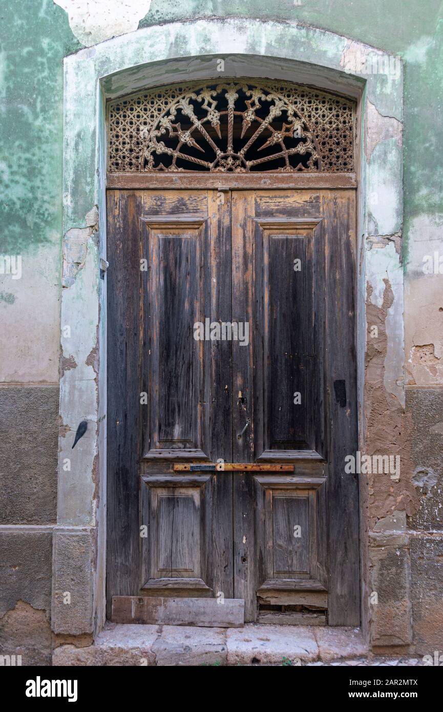 An old, broken and closed door in Portugal Stock Photo