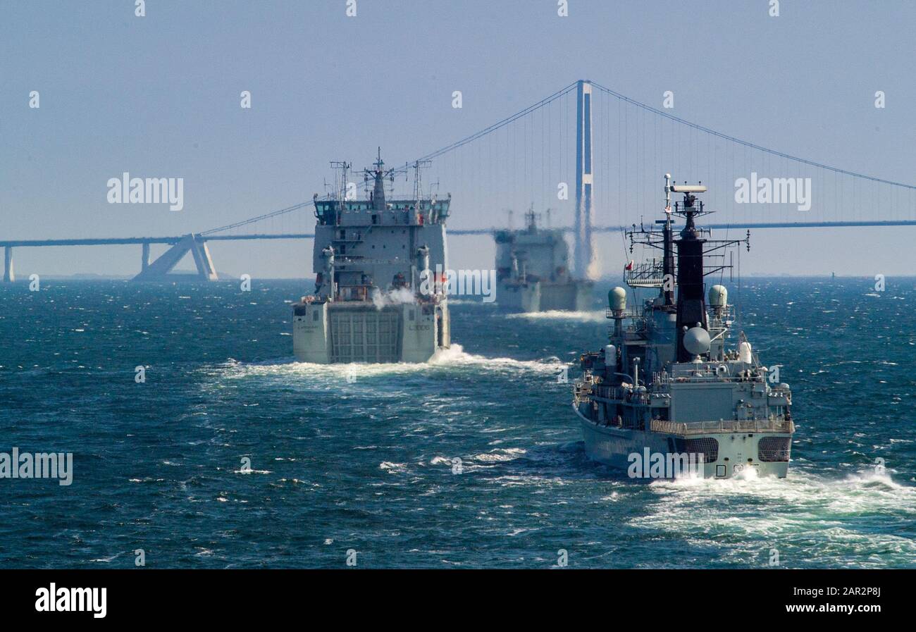 HMS Manchester astern of two Bay class amphibious ships at the Oresund suspension bridge Stock Photo