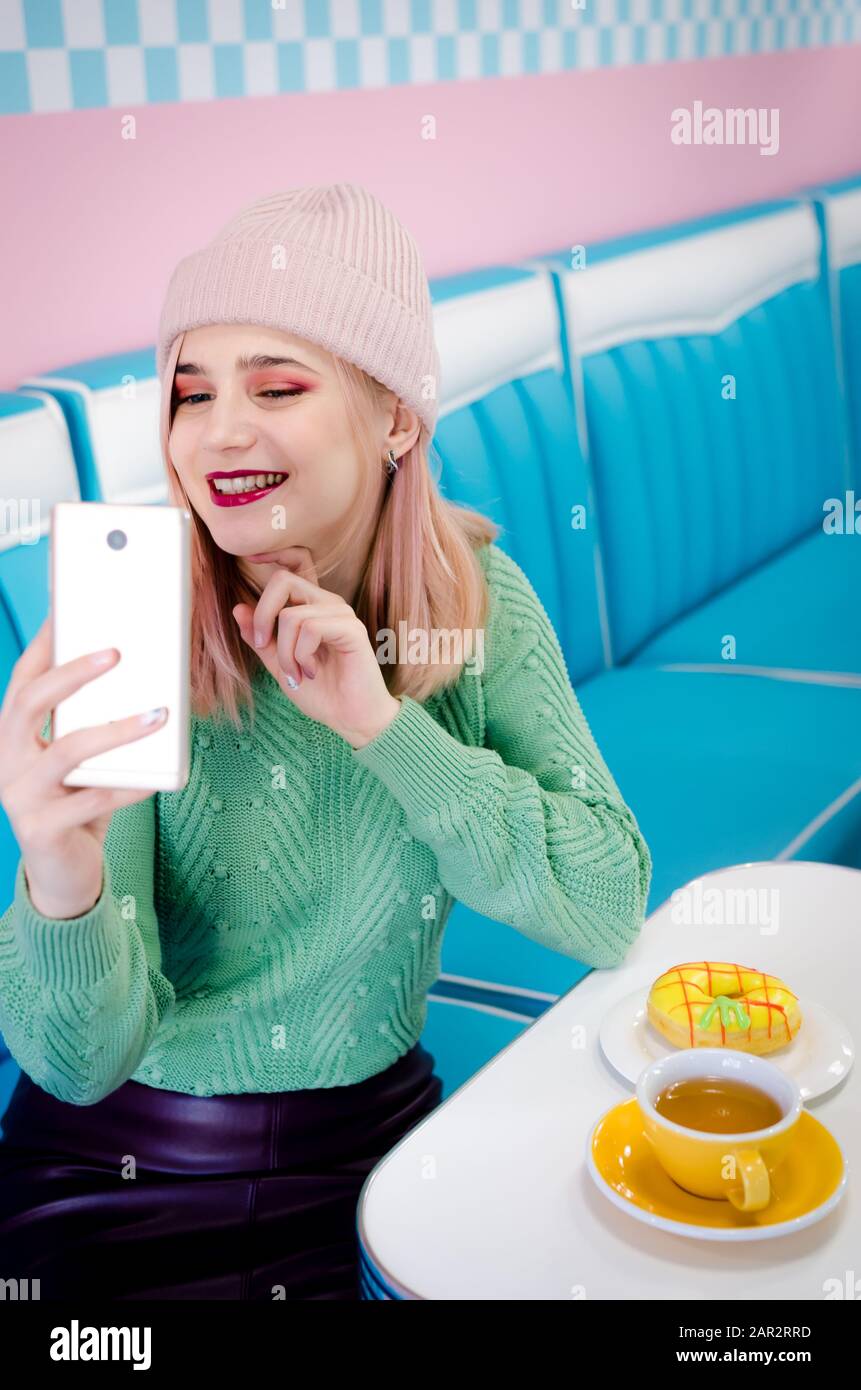 Portrait Of A Cheerful Blonde Girl Making Selfie Photo On Smartphone Blonde Girl Drinking Tea 