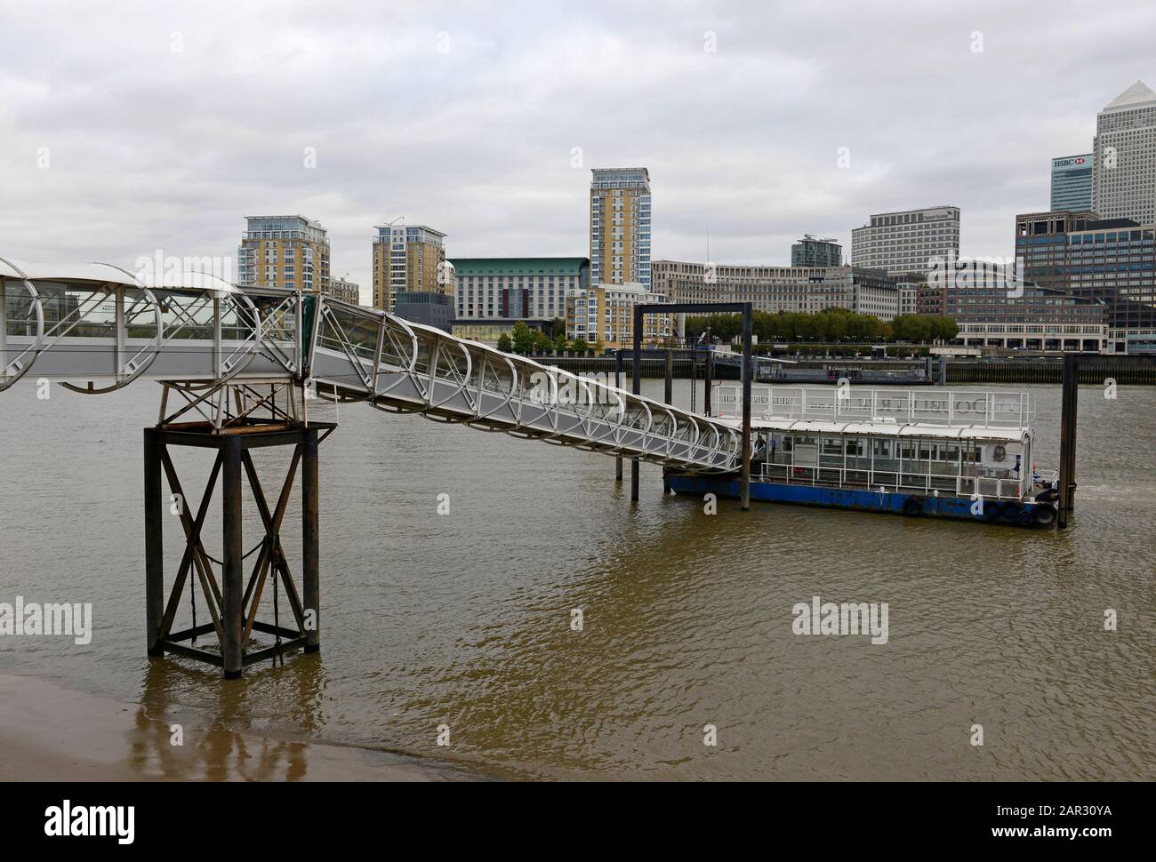 A ferry waits at Nelson Dock Pier to travel across the Thames river to Canary Wharf, London, UK Stock Photo