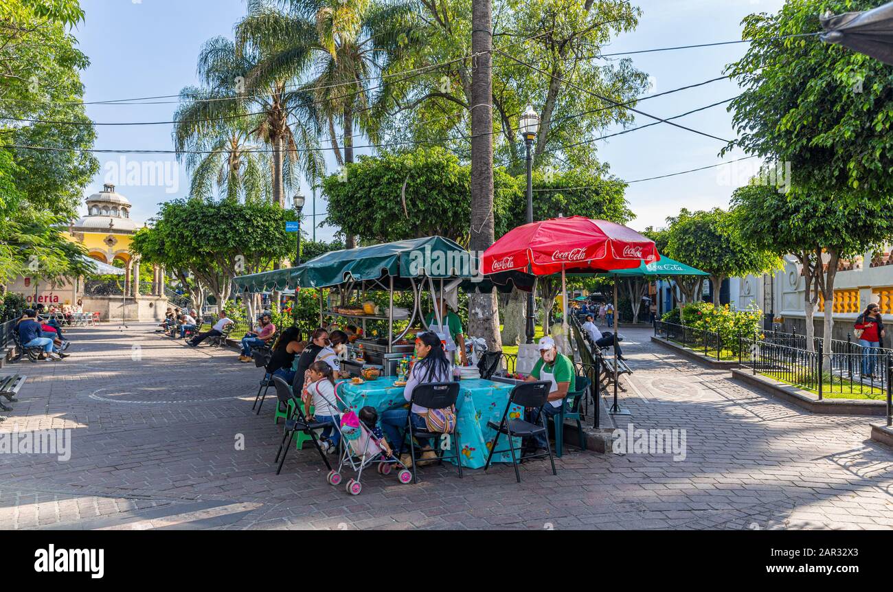San Pedro Tlaquepaque, Jalisco, Mexico - November 23, 2019: Tourists, Locals and street vendors at the hidalgo garden Stock Photo