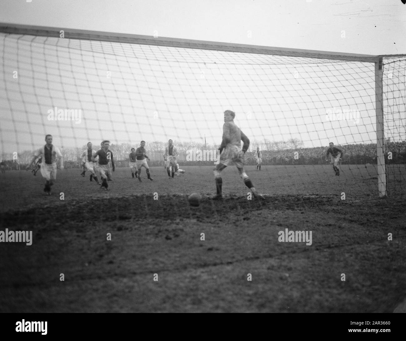 Football. HVC against Ajax 0-3. (HVC-keeper British is passed) Annotation: According to photo administration goalkeeper Jan van Greven of Ajax, but this seems incorrect Date: 16 January 1955 Location: Amersfoort Keywords: goalkeepers, sports, football Institution Name: AJAX Stock Photo