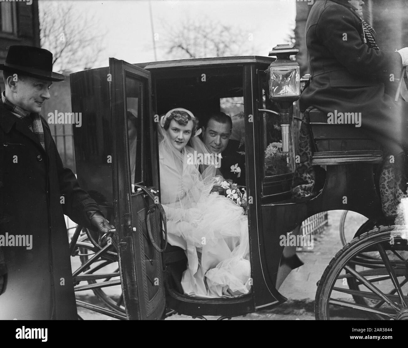 Marriage of Mr. Hans Smulders with Mary Sevenstern. Bride and groom in the carriage Annotation: J.P.M.A. Smulders (1912-) was a member of the management Anefo. Mary Sevenstern was a daughter of the owner of the distillery Sevenstern in Dieren Date: 4 January 1951 Keywords: bridal couples, marriages, carriages Personal name: Sevenstern, M., Smulders, J.P.M.A. Stock Photo