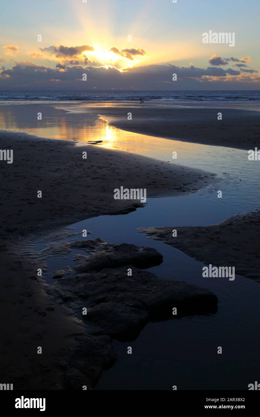 Stream flowing across beach at Dunraven Bay at sunset, near Southerndown, South Glamorgan, Wales, UK Stock Photo