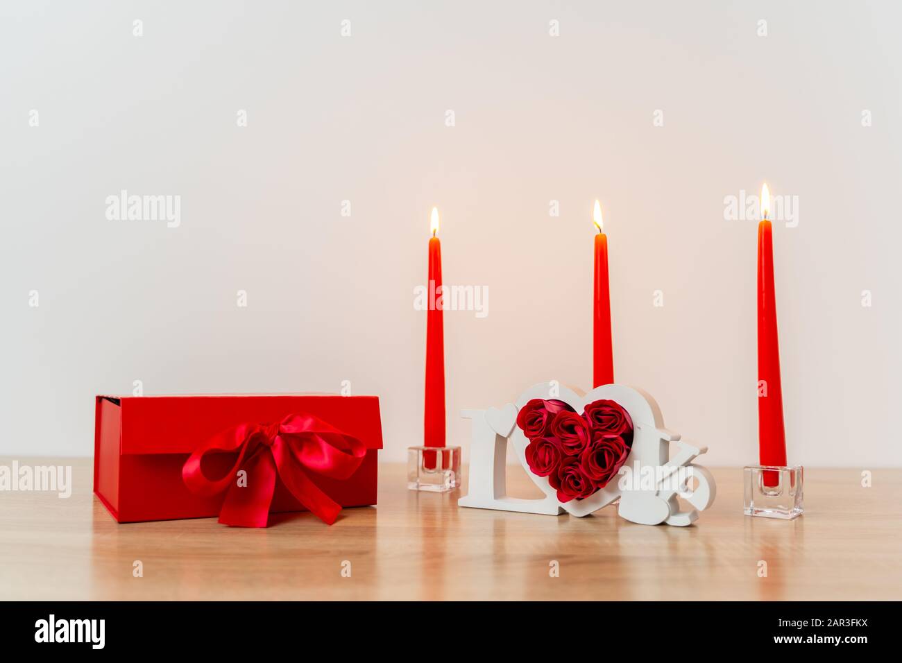 Lighted Candles For Valentines Day On Wooden Table Stock Photo