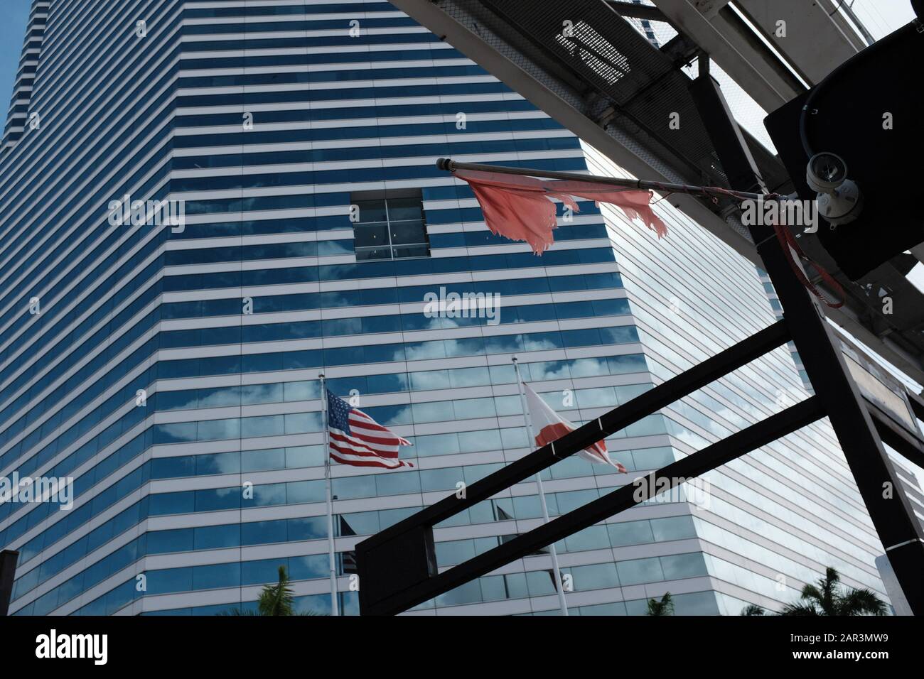 View of Miami Tower building in Downtown Miami with flags and Metromover tracks in the frame Stock Photo
