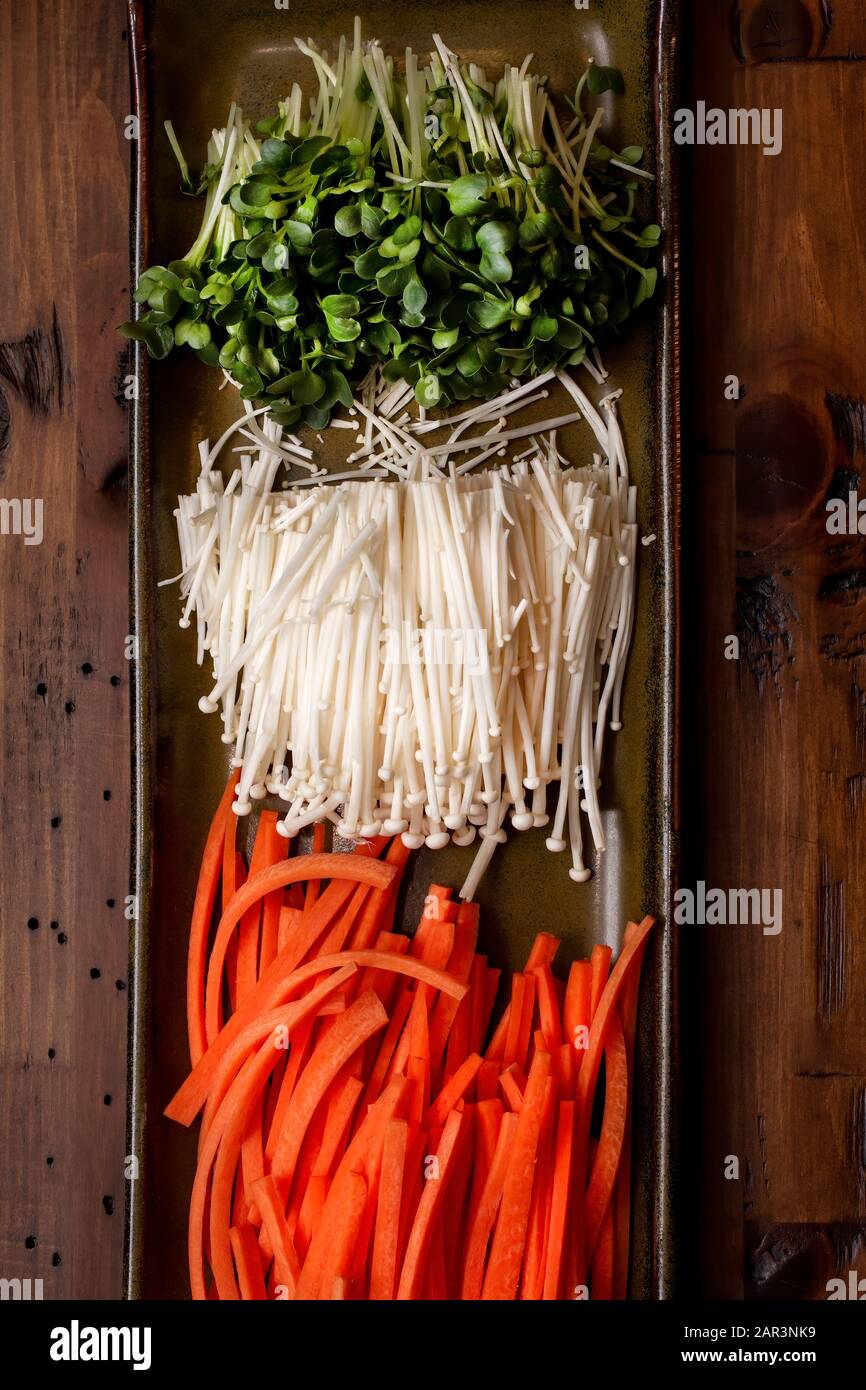 Radish sprouts, Enokitake mushrooms and carrots prepared to add as