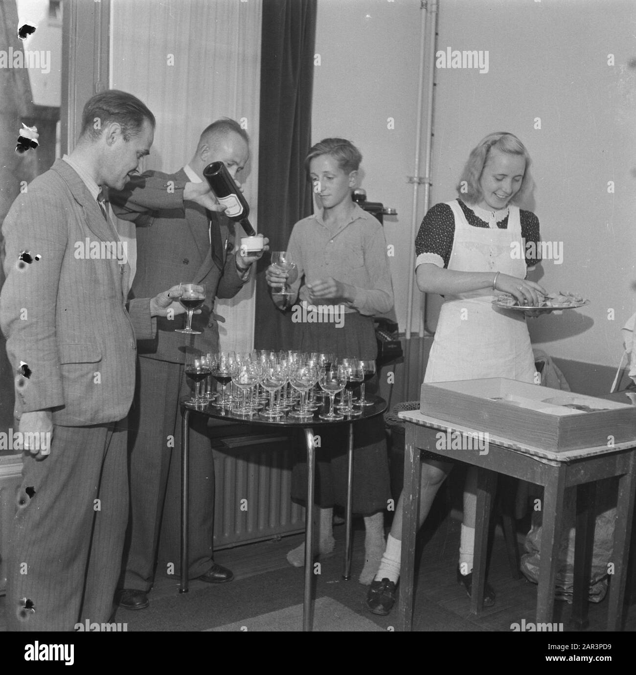Department Store. Meeting. Glassles of wine are poured in. A waitress busy with snacks Date: 1945 Keywords: World War II Stock Photo