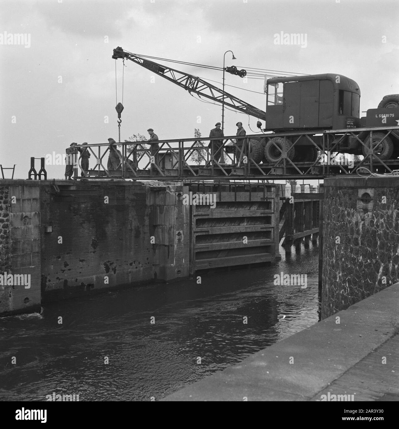 [Reconstruction, a tow truck places a bailey bridge over a lock] Date: February 14, 1946 Stock Photo