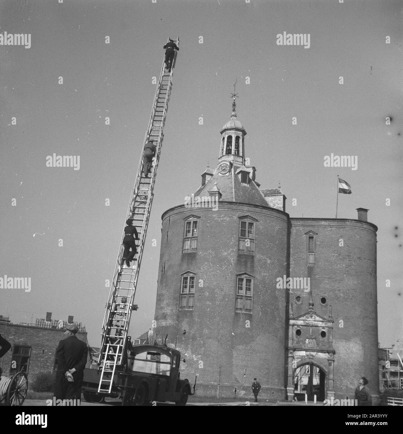 Jubilee at fire brigade Enkhuizen. Demonstrations of several fire brigades on site in front of the Dromedaris at the port. Date: 17 April 1946 Location: Enkhuizen Keywords: fire brigade, anniversaries Stock Photo