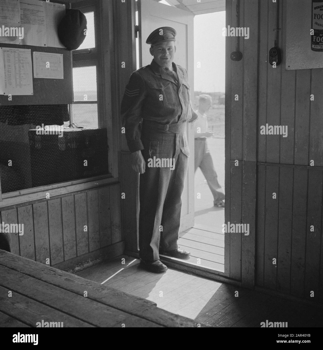KLM [Keet at the airport Schiphol? Arrival and departure, customs officer in doorway?] Date: 4 July 1946 Location: Schiphol Keywords: airports Institution name: KLM Stock Photo