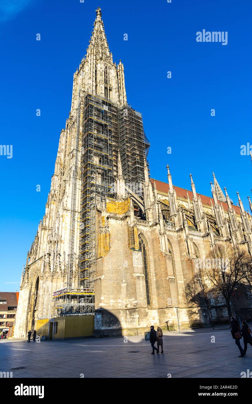 Ulm, Germany, December 29, 2019, Old minster, a gothic cathedral church building with tall steeple in old town with scaffolding, a tourist magnet Stock Photo