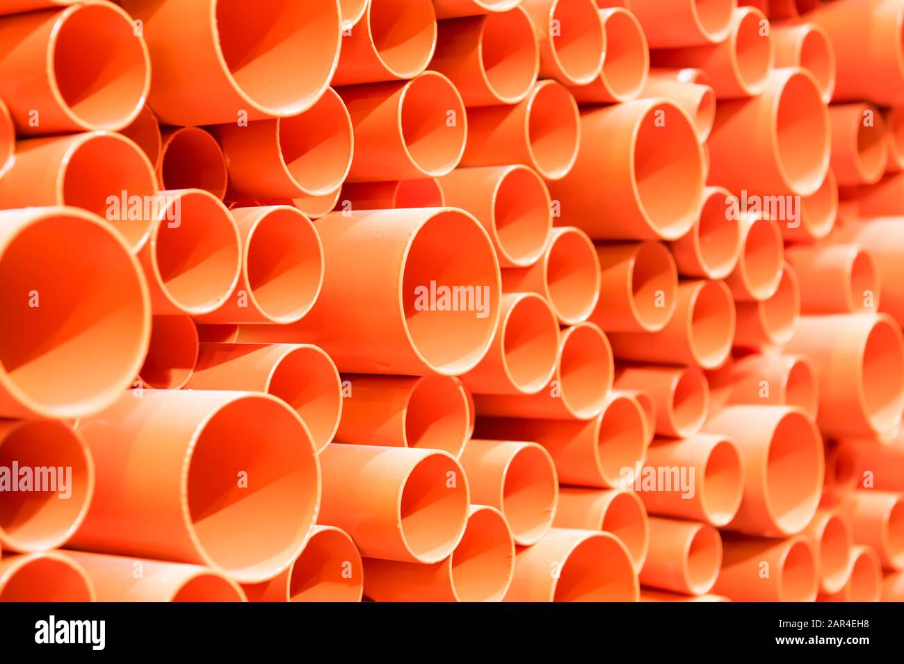 orange PVC pipes stacked in construction site Stock Photo Alamy