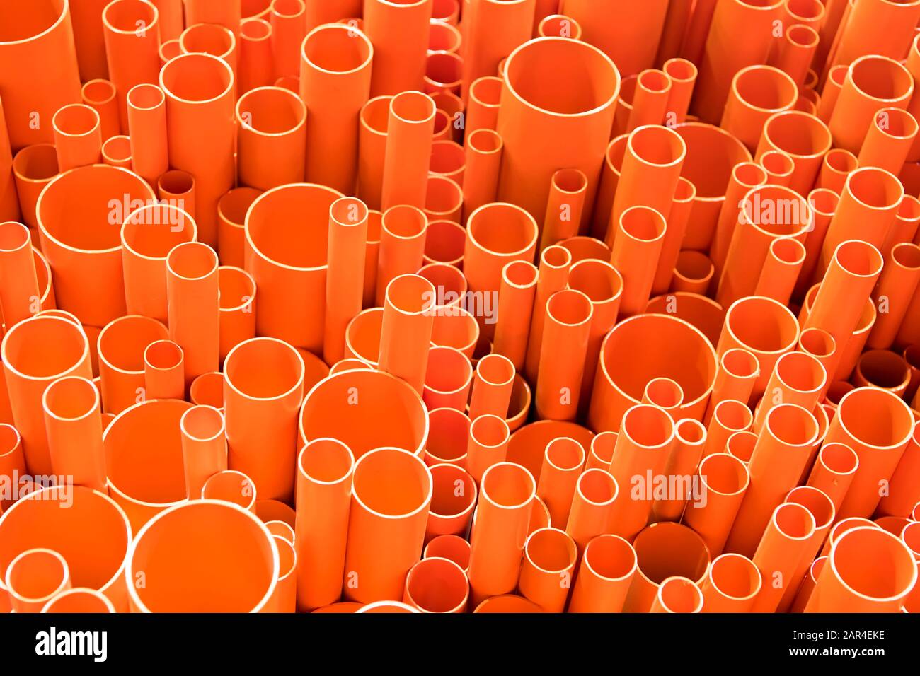 orange PVC pipes stacked in construction site Stock Photo Alamy